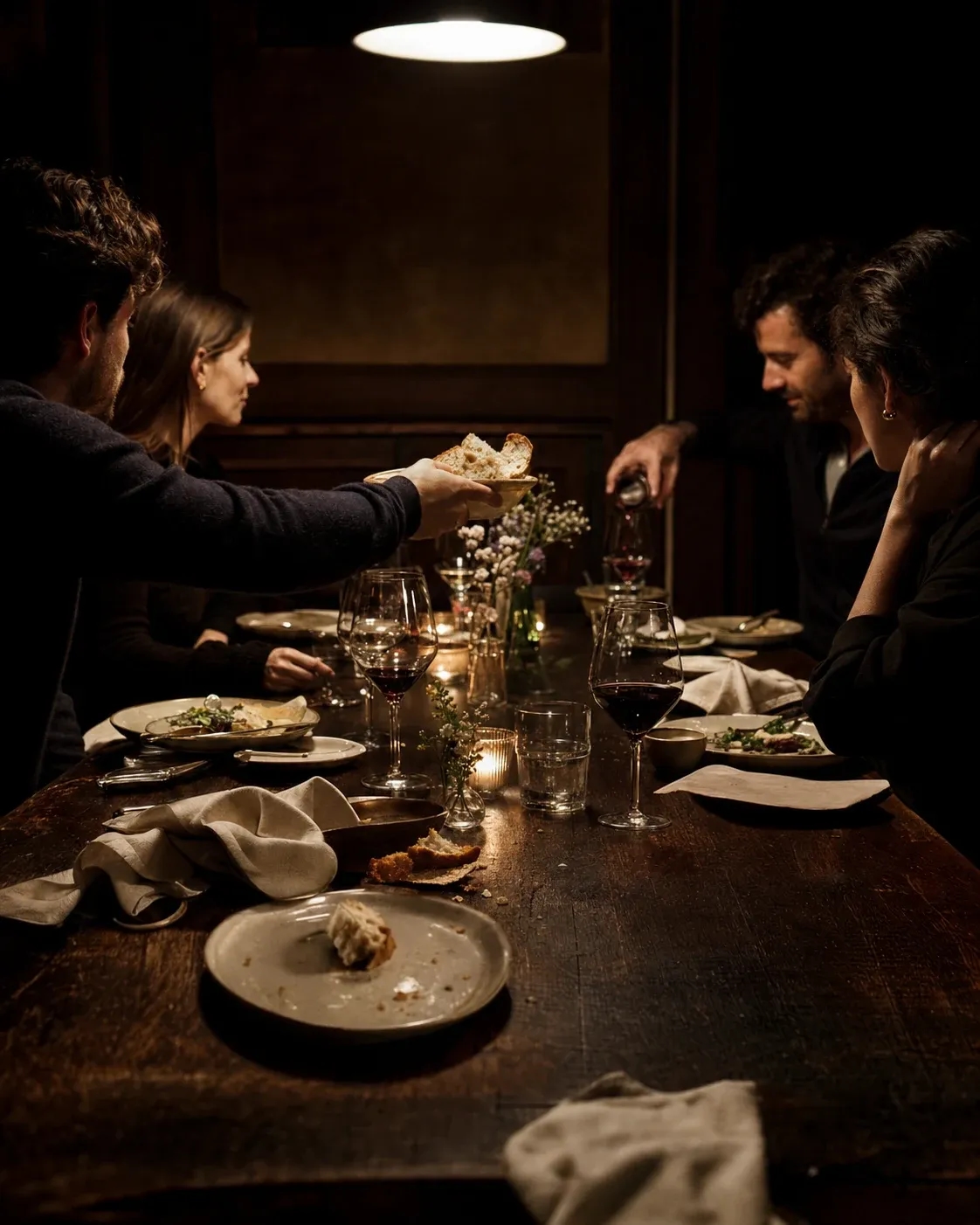 Friends sharing a relaxed candlelit dinner