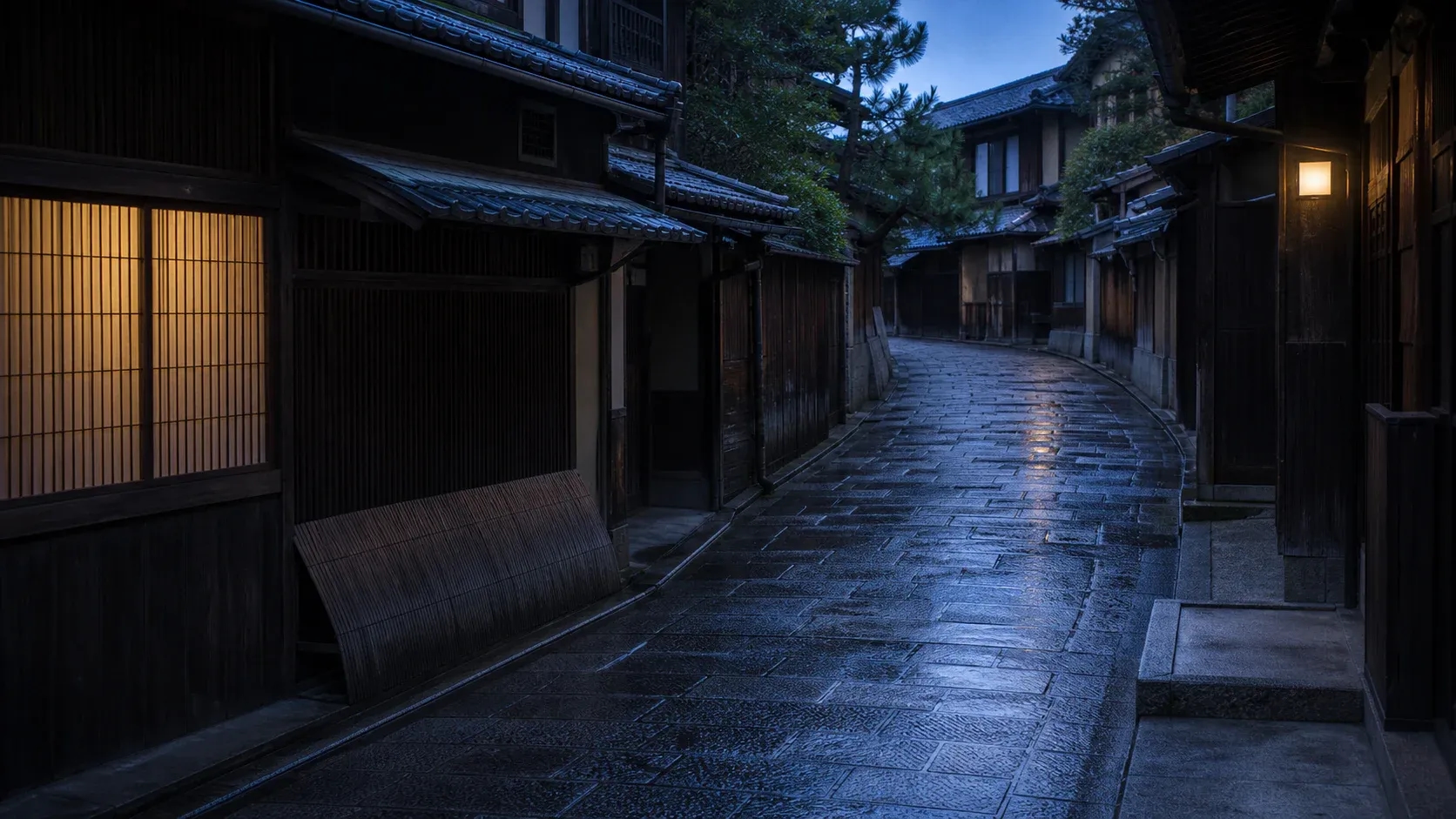 A quiet Kyoto street after rain at blue hour