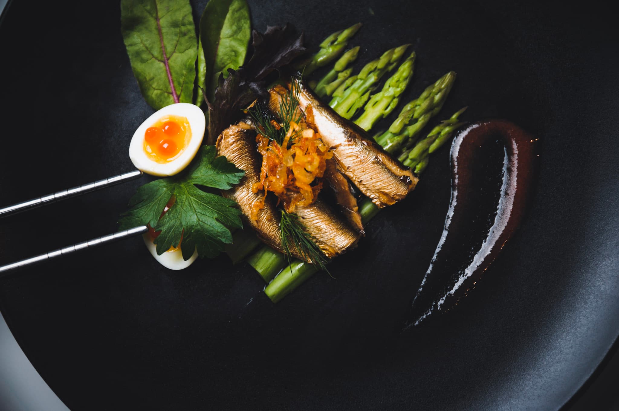 Diplomats Gourmet smoked sprats served with asparagus and egg