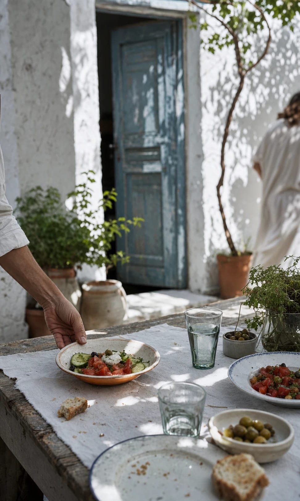 An unhurried courtyard lunch with bread and seasonal vegetables.