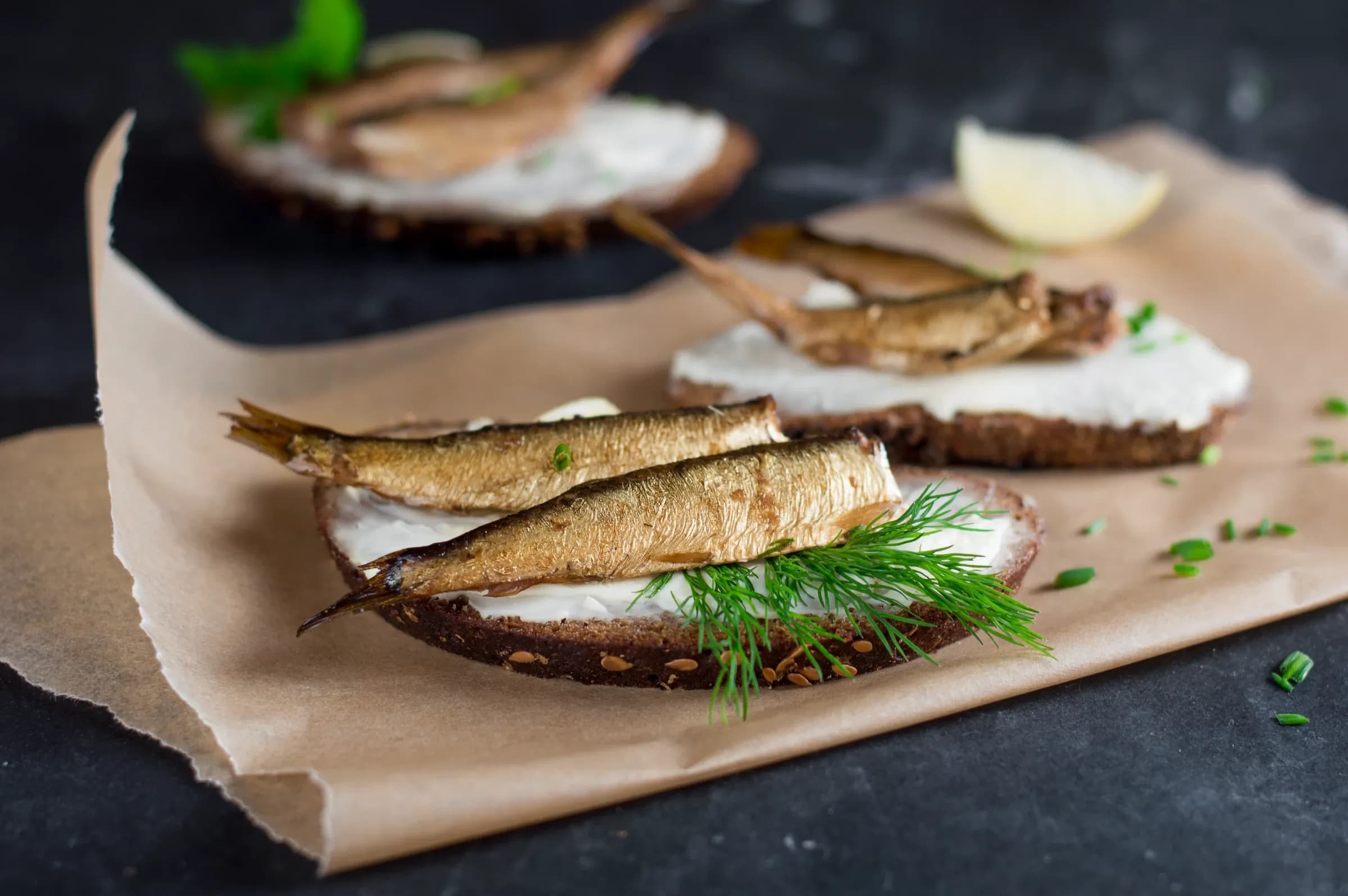 Engure sprats on rye with dill and lemon.