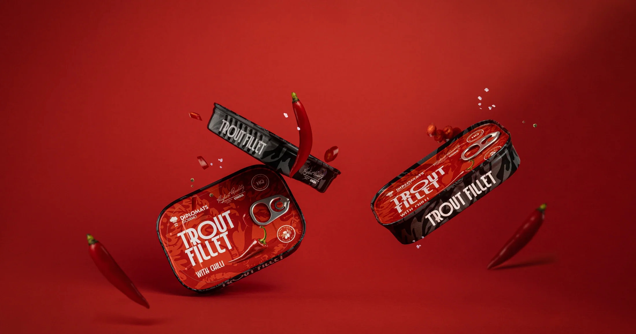 Diplomats trout products in a vivid red campaign composition